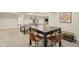 Spacious game room provides a ping pong table, table and chairs, and access to other parts of the home at 3267 Cimmaron Ash Ct, Zionsville, IN 46077