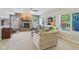 Spacious living room boasts a stone fireplace, neutral décor, and large windows that flood the area with natural light at 3267 Cimmaron Ash Ct, Zionsville, IN 46077