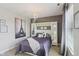 Stylish main bedroom with decorative chandelier, neutral tones, and a comfortable bed at 3267 Cimmaron Ash Ct, Zionsville, IN 46077