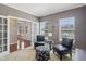 Comfortable office space with plush chairs, a stylish ottoman, and ample natural light, creating an ideal workspace at 3267 Cimmaron Ash Ct, Zionsville, IN 46077