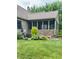Charming backyard featuring a screened porch with brick base and lush landscaping at 3559 S County Road 475 E, Plainfield, IN 46168