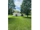 Spacious green backyard with mature trees and a white picket fence at 3559 S County Road 475 E, Plainfield, IN 46168
