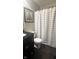 Bathroom featuring a vanity with a black countertop, a framed art piece, and a shower with a striped curtain at 3559 S County Road 475 E, Plainfield, IN 46168