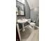 Cozy bathroom features a pedestal sink, toilet, and gray tile floors at 3559 S County Road 475 E, Plainfield, IN 46168