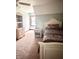 This carpeted bedroom has an off-white ceiling fan, a bed with flower-patterned bedding, and off-white dressers at 3559 S County Road 475 E, Plainfield, IN 46168
