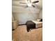 This carpeted bedroom features a ceiling fan, a bed with a gray blanket, and an off-white dresser at 3559 S County Road 475 E, Plainfield, IN 46168