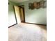 Bedroom with light green walls, plush carpet, a door to an adjacent room and decorative leaf art at 3559 S County Road 475 E, Plainfield, IN 46168