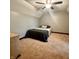This carpeted bedroom features a ceiling fan, a bed with a gray blanket, and an off-white dresser at 3559 S County Road 475 E, Plainfield, IN 46168