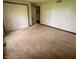 Bedroom with neutral walls, plush carpet, and a closet and a door to an adjacent room at 3559 S County Road 475 E, Plainfield, IN 46168
