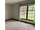 Bedroom with neutral walls, a large window with curtains, and neutral carpeted floors at 3559 S County Road 475 E, Plainfield, IN 46168