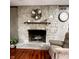 Close-up view of the stone fireplace with a decorative wreath and wooden mantel at 3559 S County Road 475 E, Plainfield, IN 46168