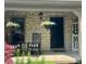 Inviting front porch with stone accent, rocking chairs, and hanging flower baskets adding to curb appeal at 3559 S County Road 475 E, Plainfield, IN 46168