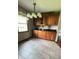 Eat-in kitchen area features a charming light fixture and custom wood cabinetry with dark countertops at 3559 S County Road 475 E, Plainfield, IN 46168