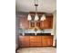 Kitchen features wood cabinets, dark countertops, decorative backsplash and a pendant light fixture at 3559 S County Road 475 E, Plainfield, IN 46168