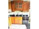 Spacious kitchen featuring custom wood cabinets with black appliances and tile backsplash at 3559 S County Road 475 E, Plainfield, IN 46168
