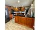 Open concept kitchen with wood cabinets, black appliances, and granite countertops, creating a modern space at 3559 S County Road 475 E, Plainfield, IN 46168