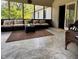 Outdoor porch with neutral concrete floor, outdoor wicker seating and a view of the wooded area at 3559 S County Road 475 E, Plainfield, IN 46168