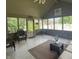 This sunroom features many windows, patio furniture, and a gray concrete floor at 3559 S County Road 475 E, Plainfield, IN 46168