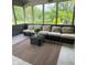 Cozy screened-in porch with comfortable seating and a woven outdoor rug at 3559 S County Road 475 E, Plainfield, IN 46168