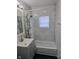 Updated bathroom with stylish vanity, mirror, and shower-tub combination at 3644 N Parker Ave, Indianapolis, IN 46218