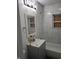 Modern bathroom with new marble-style tiling, vanity, and updated fixtures at 3644 N Parker Ave, Indianapolis, IN 46218