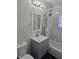 Updated bathroom with stylish vanity, mirror, and shower-tub combination at 3644 N Parker Ave, Indianapolis, IN 46218