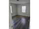Bright bedroom with hardwood flooring and natural light from two windows at 3644 N Parker Ave, Indianapolis, IN 46218