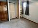 Bedroom with wooden door, built-in shelving and a window that provides natural light at 3645 Winings Ave, Indianapolis, IN 46221