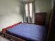 Bedroom with bed, dresser, grey curtains and plenty of natural light at 3645 Winings Ave, Indianapolis, IN 46221