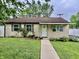 Charming single-story home featuring well-manicured landscaping and a welcoming covered porch at 3645 Winings Ave, Indianapolis, IN 46221