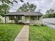 Charming single-story home featuring a well-manicured lawn and decorative landscaping at 3645 Winings Ave, Indianapolis, IN 46221
