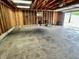 Spacious garage with unfinished wooden beams and a large concrete floor at 3645 Winings Ave, Indianapolis, IN 46221