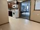 Efficient kitchen overlooking a adjacent room with carpet, connecting cooking and living spaces at 3645 Winings Ave, Indianapolis, IN 46221