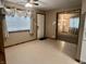 Inviting living room with white floors, natural light, and an open doorway at 3645 Winings Ave, Indianapolis, IN 46221
