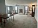 Spacious living room featuring a ceiling fan, chair, and multiple windows for natural light at 3645 Winings Ave, Indianapolis, IN 46221