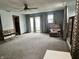 Cozy living room with carpeting, a ceiling fan, and a large armchair, offering comfort and style at 3645 Winings Ave, Indianapolis, IN 46221