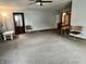 Open living room featuring neutral walls, updated carpet and ceiling fan at 3645 Winings Ave, Indianapolis, IN 46221
