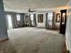 Expansive living room with neutral carpet, multiple windows, and classic art pieces at 3645 Winings Ave, Indianapolis, IN 46221