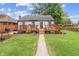 Charming home with a well-maintained lawn, inviting deck, and manicured landscaping at 3702 N Chester Ave, Indianapolis, IN 46218