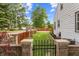 Landscaped backyard featuring a lush lawn, wooden fence, and gated entrance at 3702 N Chester Ave, Indianapolis, IN 46218