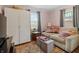 Bedroom featuring a comfortable couch, natural light from the window, ample storage, and decor at 3702 N Chester Ave, Indianapolis, IN 46218