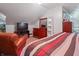 Bedroom featuring a comfortable chair, natural light, ample storage, mirror and a television at 3702 N Chester Ave, Indianapolis, IN 46218