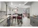 Bright dining room with a ceiling fan, access to the backyard and granite countertops on the kitchen island at 3702 N Chester Ave, Indianapolis, IN 46218