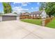 Spacious backyard with a large driveway, detached garage, and inviting deck perfect for outdoor gatherings at 3702 N Chester Ave, Indianapolis, IN 46218