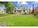 Charming stone house with a well-manicured lawn and inviting front porch and a traditional walkway to the front door at 3702 N Chester Ave, Indianapolis, IN 46218