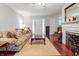 Cozy living room featuring hardwood floors, a fireplace and comfortable seating with a beautiful decorative rug at 3702 N Chester Ave, Indianapolis, IN 46218