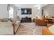Inviting living room with a neutral color scheme, comfortable seating, and an entertainment center with a large television at 3702 N Chester Ave, Indianapolis, IN 46218