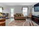 Inviting living room with a neutral color scheme, comfortable seating, and an entertainment center with a large television at 3702 N Chester Ave, Indianapolis, IN 46218