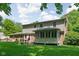 Spacious backyard featuring a deck, screened porch, and mature trees, providing ample space for outdoor enjoyment and entertaining at 38 Hawthorne Ct, Carmel, IN 46033