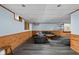Comfortable finished basement with wood trim, a large sectional sofa, and luxury vinyl plank flooring at 38 Hawthorne Ct, Carmel, IN 46033